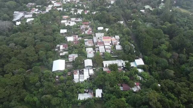 Simple Houses Surrounded  By Verdant Trees In A Small Town In Near El Boqueron In El Salvador - aerial drone