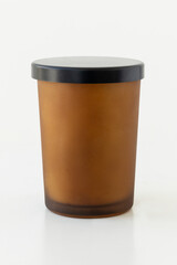 Brown candle vessel with black lid