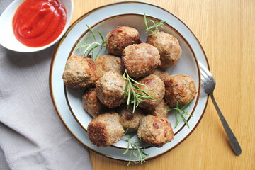 Roasted meatballs , delicious meat cutlets on wooden table . Top view