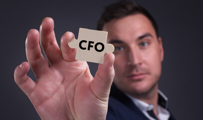 Business, Technology, Internet and network concept. Young businessman shows the word: CFO