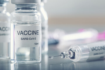 Covid-19 coronavirus vaccine in a ampoule with syringe ready for vaccination