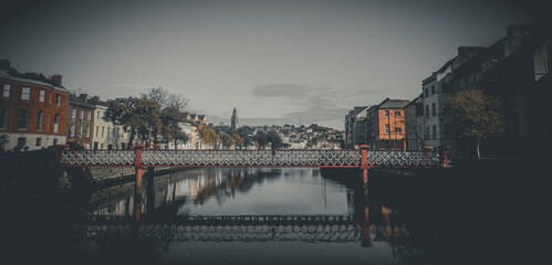 Fototapeta na wymiar View of Cork. St. Vincent's footbridge over Lee river. Republic of Ireland