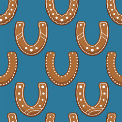 Seamless pattern with gingerbread cookies horseshoes. Blue background. Vector illustration.