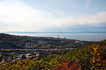 Far East of Russia, Vladivostok city. Sea of Japan, hills, buildings, roads, greenery. Panoramic view from above.