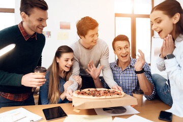 Group of young happy people eating pizza.