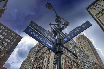 Road instersection sign in Midtown Manhattan under a coming storm, New York, USA