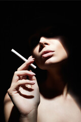 Obraz premium Beautiful woman with a cigarette. Retro style portrait