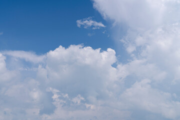 Fototapeta na wymiar soft flufly clouds on bright clear blue sky