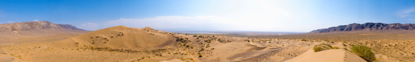 Sand dunes with clouds backgorund. Natural landscape. Altyn-Emel singing dunes or barkhan....