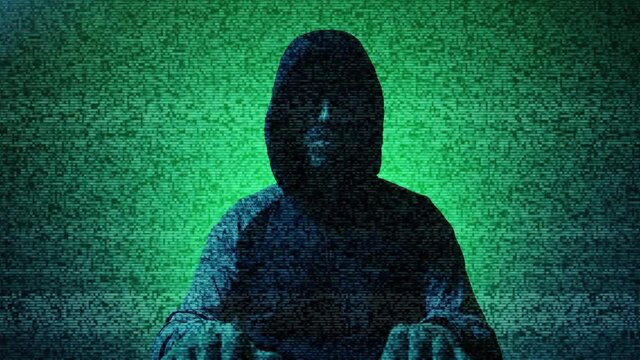 Silhouette of male hacker sitting in front of the camera, with hood and glasses, typing and looking at the computer screen, with television noise effect. Concept of dark internet, deep web.