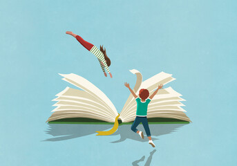 Exuberant boy watching girl dive into book

