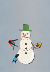 Kids assembling paper snowman
