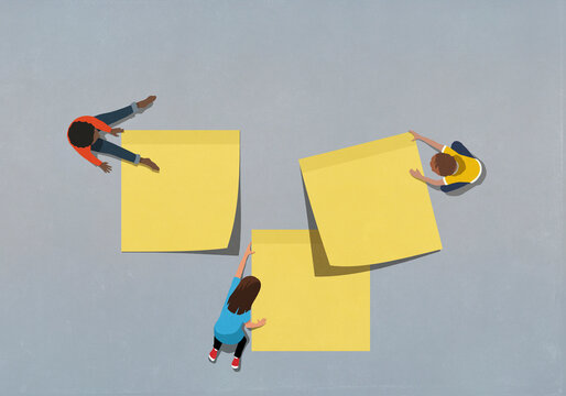 Children with large yellow adhesive notes
