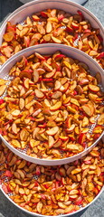 Dried cut apples in white round plastic trays for drying