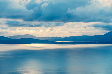picturesque view on sea coastline and cloudy sunset sky
