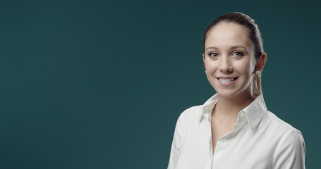 Smiling young woman in white shirt