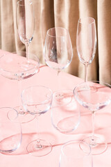 Many empty crystal glasses for wine, cocktail and champagne on the table. Preparation for the party. Conceptual still life photo.
