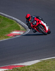 A shot of a racing bike cornering on a track.
