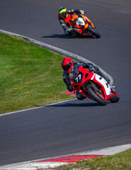 A shot of two racing bikes cornering on a track.