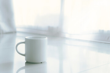 Coffee mug in the morning time with soft light.