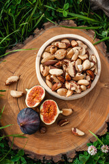 Photo for the catalog. Brazil nuts and fresh figs. Place your text under the logo.