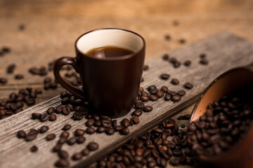 Coffee and coffee beans on old rustic wood table