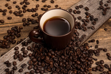 Coffee and coffee beans on old rustic wood table