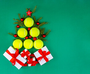 Yellow tennis balls making a shape of christmas tree with presents. Xmas and New year concept. Top view. Flat lay