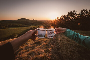 camping on the hill with cups of coffee