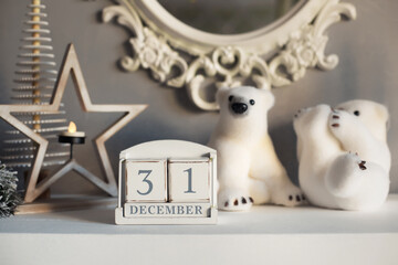 Christmas cozy decoration in white colors with wooden calendar, toys and candles