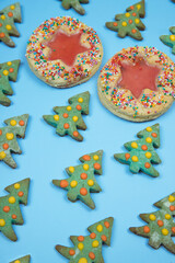Christmas homemade cookies laid out in rows in a pattern on a blue background .Vertical orientation.