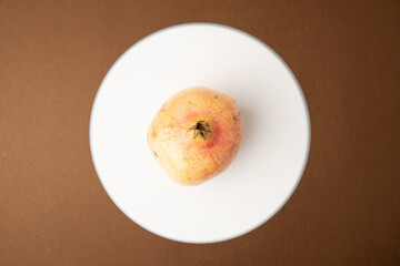 pomegranate fruit on brown background
