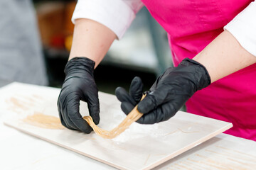Step-by-step Easter cake, pastry chef prepares dough with raisins for festive kulich