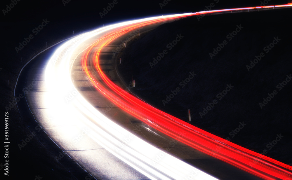 Wall mural trails of cars at night on a road. long time exposure.