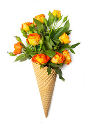 Fresh yellow-orange spray roses in a waffle cone on a white background. Copy space, flat lay.