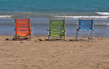 Three colored beach chairs