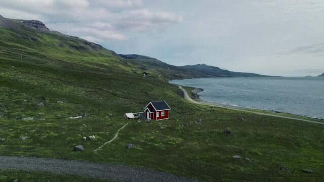 Small red house on fjord landscape in scandinavia. High quality 4k footage