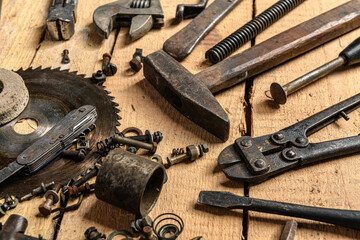 Variety of old vintage household hand tools still life on a wooden background in a DIY and repair concept