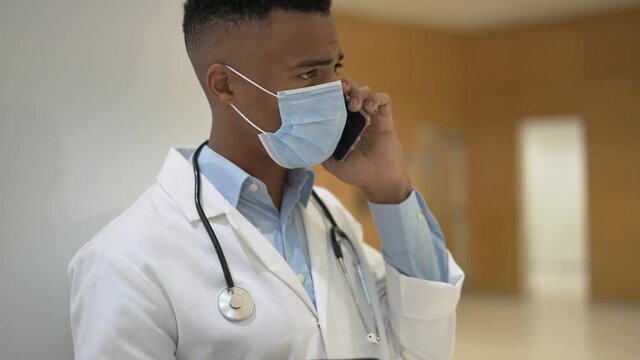Portrait of young doctor with face mask at the hospital