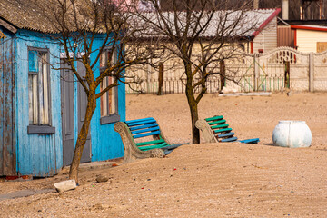 abandoned sea resort. Wood abandoned house at the beach, taken over by the desert sand.