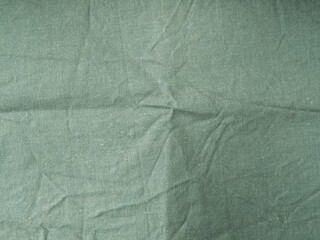 Green linen macro texture background with creases
