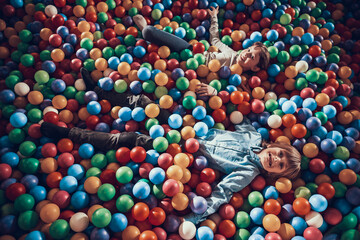 Children have fun while they lie in balls. 