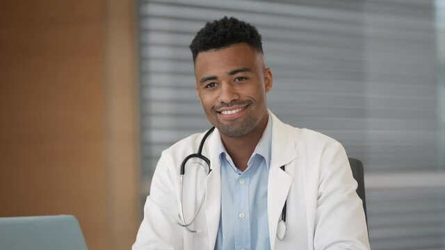 Portrait of smiling young medical intern working at the hospital