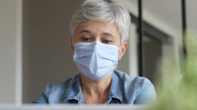 55 Year Old Senior Woman With White Hair Working Out With Mask