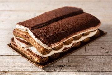 Traditional tiramisu cake on wooden table