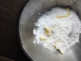 Wheat flour, butter and icing sugar in mixing bowl