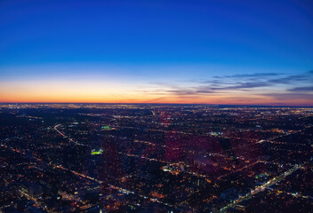Obraz premium Aerial view of city skyline at dusk. Sunset sky colors
