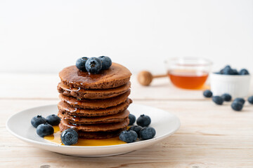chocolate pancake stack with blueberry and honey