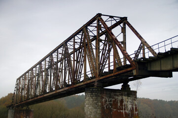 Fototapeta na wymiar Old steel riveted and forgotten bridge