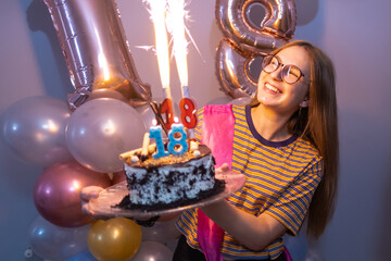 Blonde girl smiling with a cake